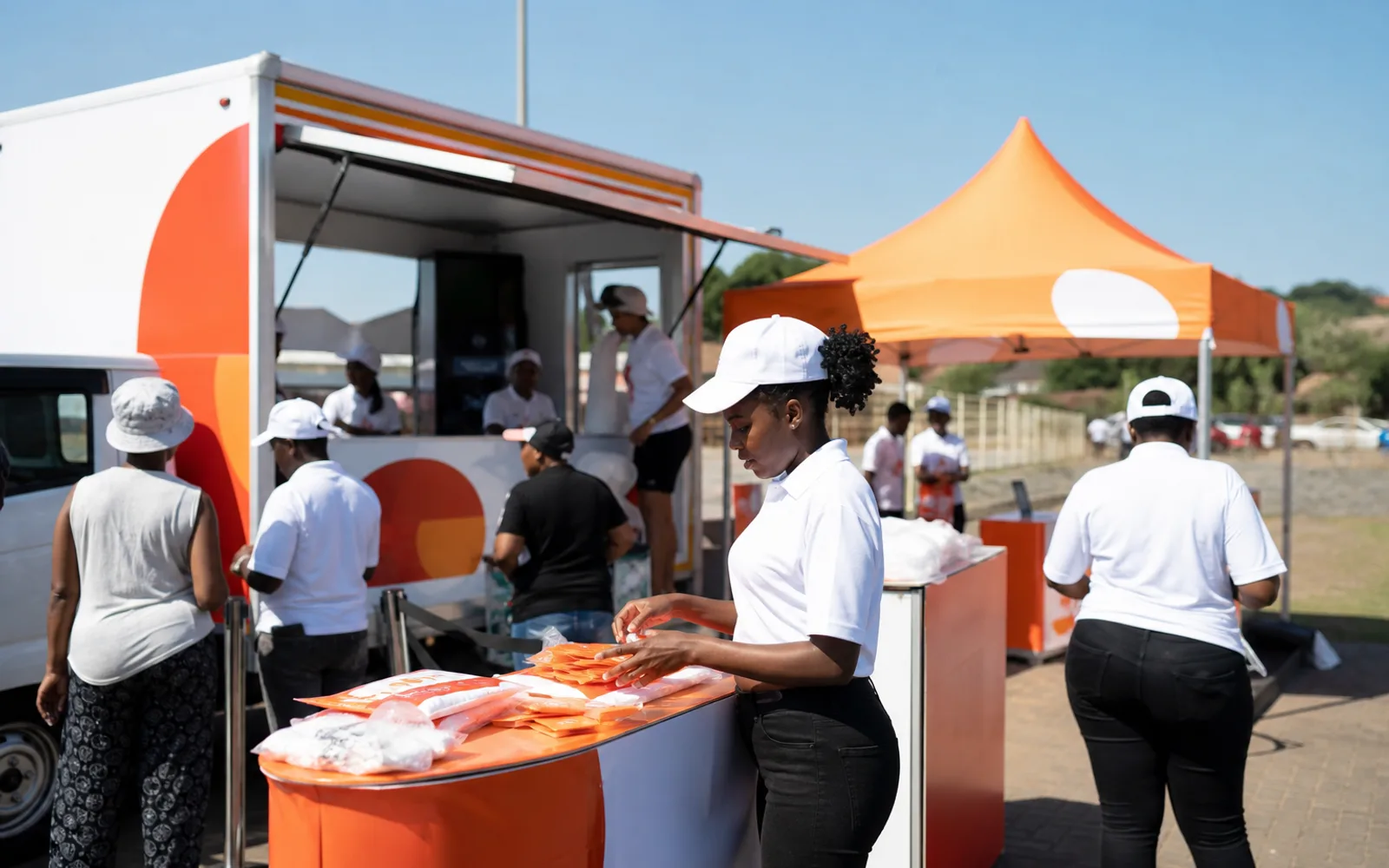Branded roadshow setup with campaign staff preparing materials in KwaZulu-Natal
